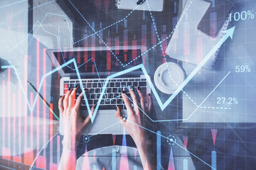 Double exposure of woman hands working on computer and forex chart hologram drawing. Top View. Financial analysis concept.