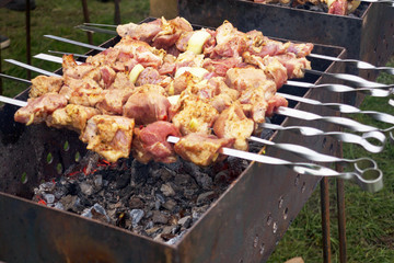 Grilled kebab cooking on metal skewer. Roasted meat cooked at barbecue.Traditional eastern dish,...