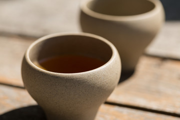 Ceramic bowls made of clay on a wooden background.