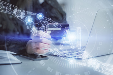 Double exposure of woman on-line shopping holding a credit card and data theme hologram drawing. E-commerce concept.