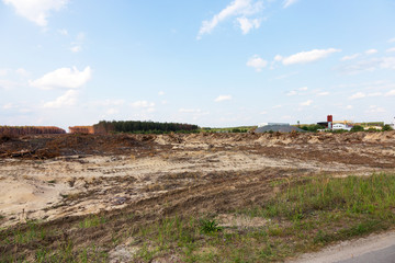 Deforestation. Uprooting of roots of trees. Chaotic deforestation in country with small economy leads to baldness and climatic natural disasters. Destruction of forest to illegal mining of amber.