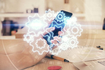 Double exposure of man's hands holding and using a phone and international business theme drawing.