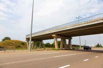 Abandoned unfinished bridge over the motorway. Overpass. The construction of the bridge. The destroyed bridge.
