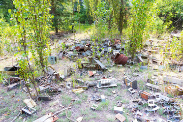 Radioactive dead zone of Chernobyl. Abandoned looted appliances, cars, electronics in Chernobyl accident. Consequences of evacuation, looting and vandalism after an explosion