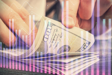 Multi exposure of forex graph drawing hologram and USA dollars bills and man hands. Technical Analysis concept.