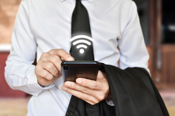 Man hand using mobile smartphone with wifi icon. Idea for business communication social network.