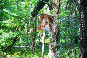 Old rusty metal signs in the Chernobyl zone. Radioactive area. Warning about dangerous area