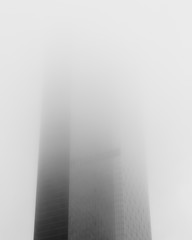 One Manhattan Square building in fog , black and white photo.