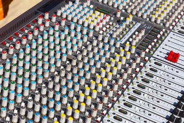 Obraz premium Remote sound engineer. Remote control of the sound engineer shallow depth of field.