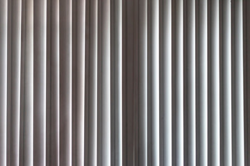 Vertical window blinds. Real blind curtains. Striped background with silver jalousie