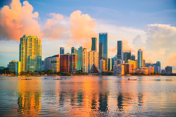 Obraz na płótnie Canvas downtown miami florida at sunset reflections buildings sea people boats cityscape 
