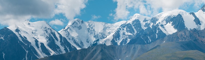 Snow-capped mountain peaks. Traveling in the mountains, climbing. Panoramic view.