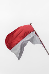 Indonesian flag waving with cloudy sky background