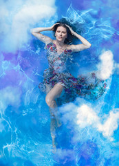 Beautiful woman in a blue crystal water.