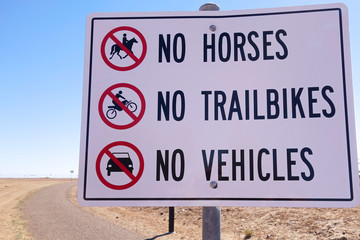 No horses, no trailbikes, no vehicles signage on an outback road in Australia.