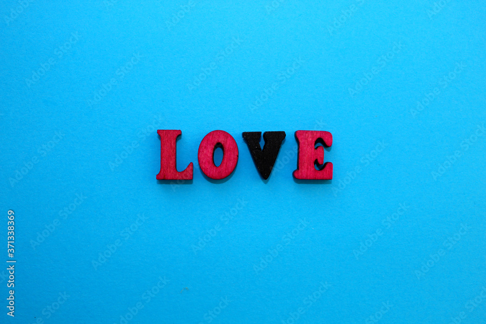 Fototapete the letters of the alphabet are laid out on a blue background in the form of a word. .