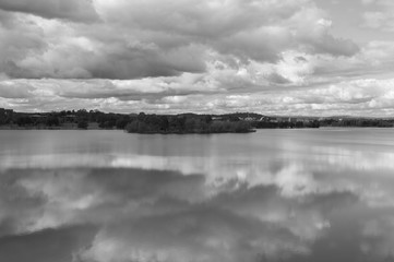 View of Canberra City from across Lake Burley Griffin. Overcast day, and in black and white.