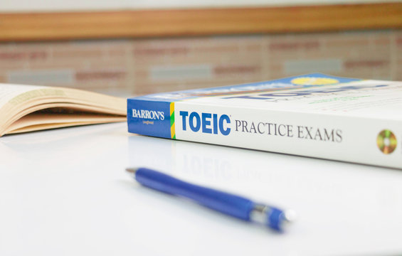 TOEIC practice exams book on white table