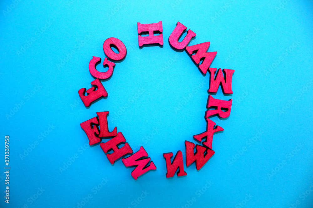 Fototapete the letters of the alphabet are laid out on a blue background in the form of a circle.