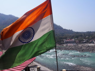 Indian national flag swaying in the wind and the beautiful Ganges behind, Rishikesh, Uttarakhand,...