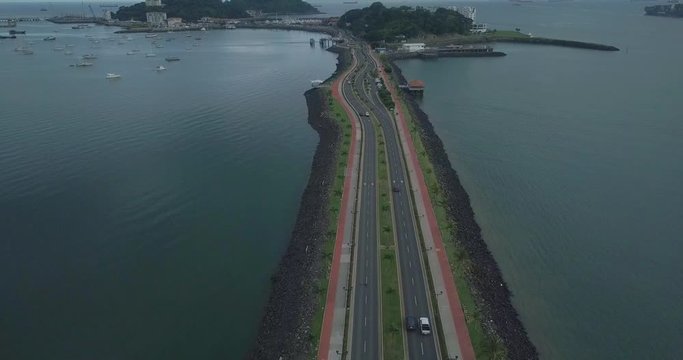 Aerial Tracking Shot High Above A Four Lane Causeway, Right of Center, Panama