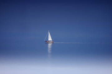 Beautiful lonely white  sailboat in the middle of the sea   