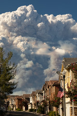 Californian seasonal fire with high smoke cloud in suburban neighborhood