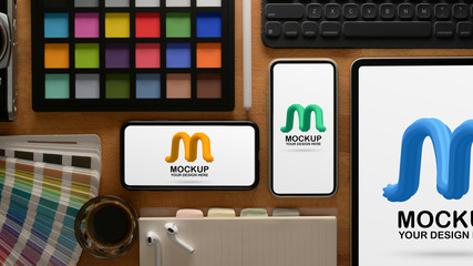 Designer workspace with mock up digital devices and paint tools
