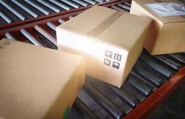 Shipment, Parcel boxes, Delivery warehouse. Cardboard boxes sorting on conveyor belt.