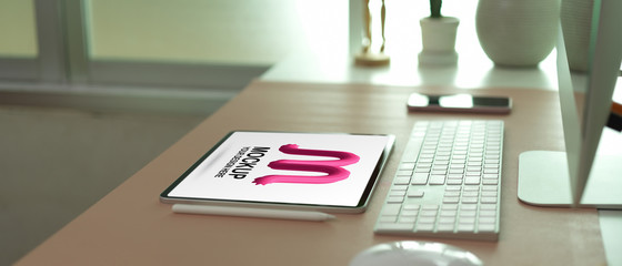Modern office desk with mock up tablet, computer and office supplies
