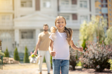 Fair-haired cute girl looking happy and excited