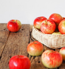 Agricultural apple background. Red early ripe apples on a wooden background.
