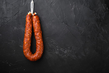 Spanish pork chorizo sausages  on black background with space for text - obrazy, fototapety, plakaty