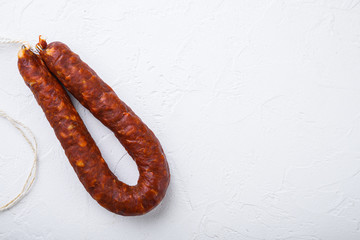 Spanish chorizo sausage on white background, topview with space for text - obrazy, fototapety, plakaty