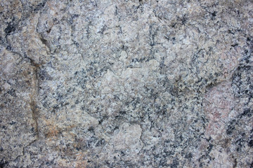 Close-up of granite rock. Natural stone wall background. Selective focus. Texture of stone