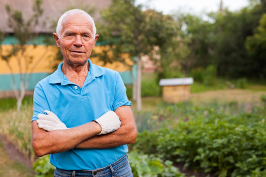 Portrait of positive mature farmer in his garden. High quality photo