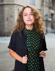 Smiling young woman standing outdoors in historical center of Barcelona