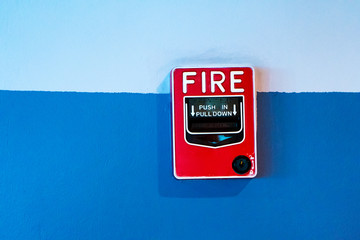 Red button handbrake fire alarm on the wall.