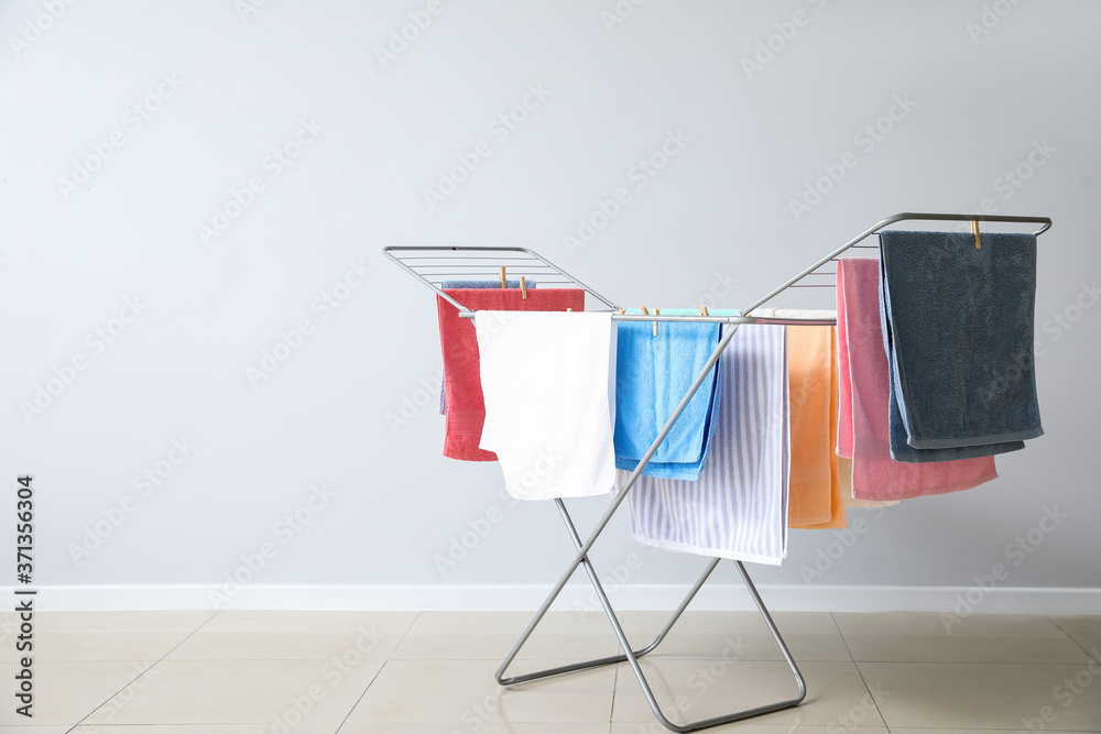 Wall mural clean towels hanging on dryer indoors