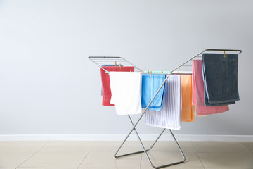 Clean towels hanging on dryer indoors