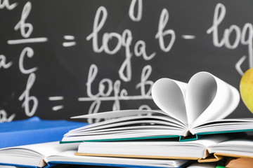 Books against blackboard in classroom