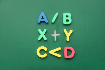 Letters and mathematical signs on color background