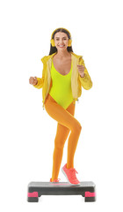 Young woman doing aerobics on white background