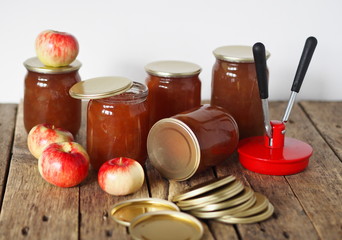 The process of rolling jam into glass jars for further storage. Homemade autumn preserves.