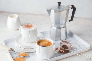 Obraz na płótnie Canvas Tray with cups of hot coffee on table