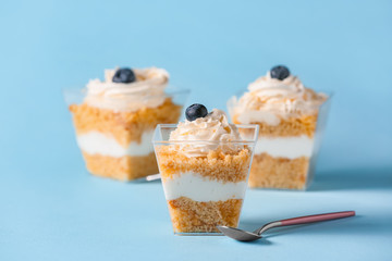 Delicious cupcake in jar on color background