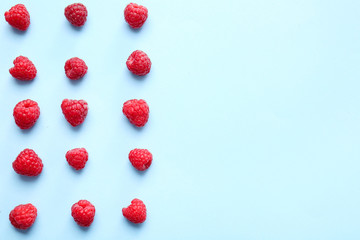 Tasty ripe raspberries on color background