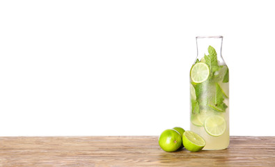 Bottle of fresh mojito on table against white background