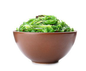 Bowl with tasty seaweed salad on white background