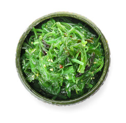 Bowl with tasty seaweed salad on white background